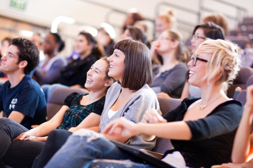 Students in a classroom, intent on the presentation Listening