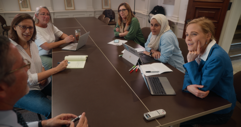 Photo of HET cohort working at a table