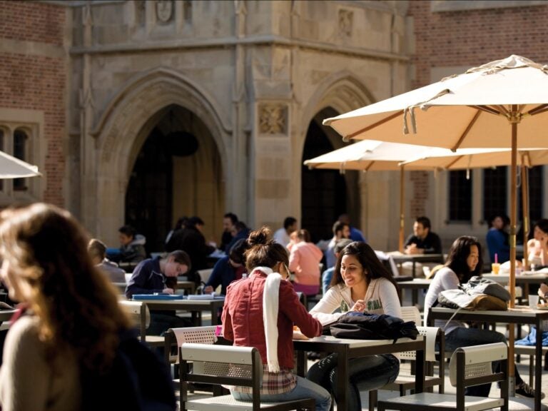 Image of students sitting at tables outside Kerckhoff Hall