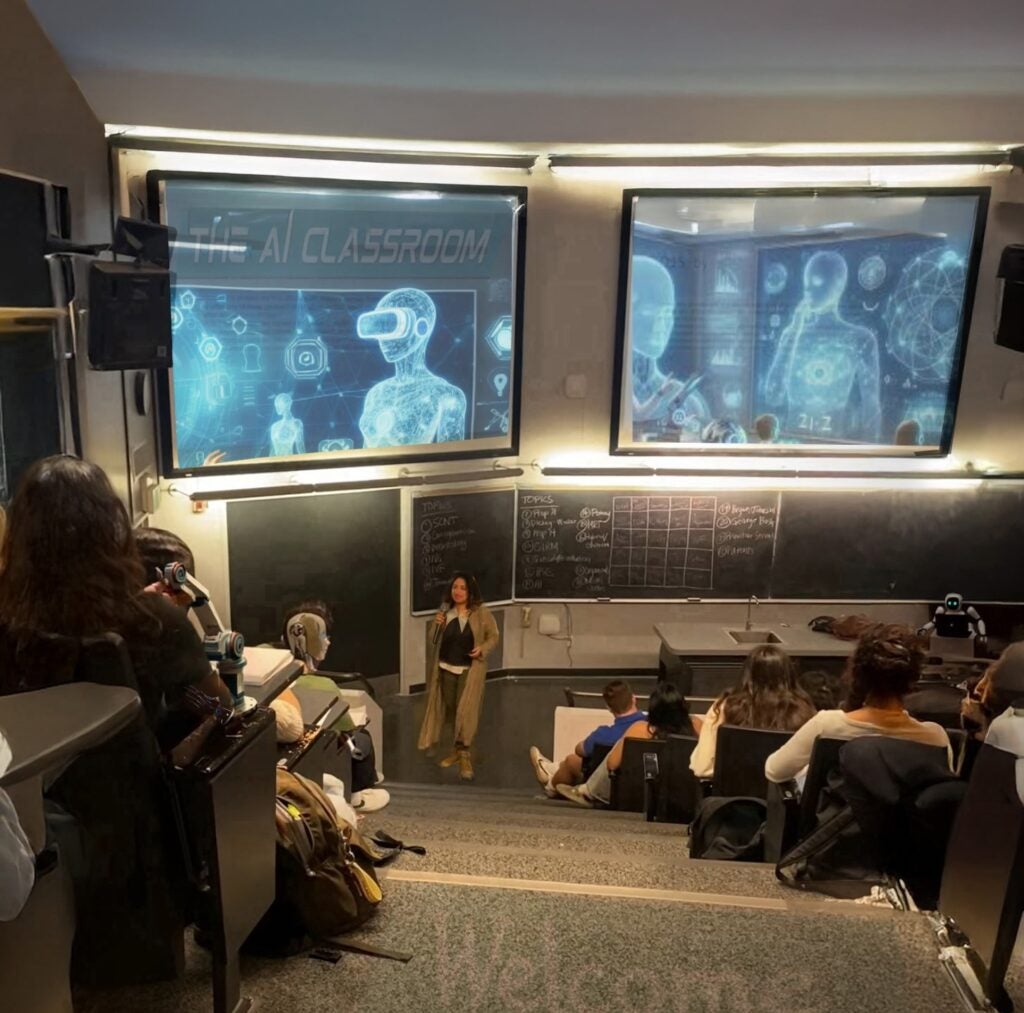 Lecture hall with screens displaying VR headsets