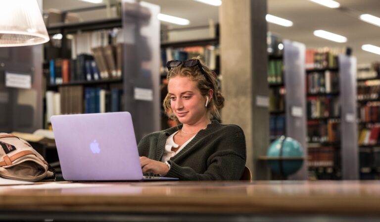 Photo of a student on a laptop in Young Research Library