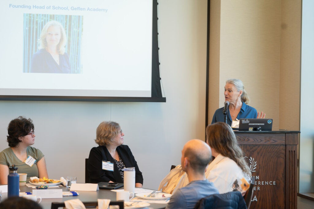 Photo of a woman standing at a podium talking.