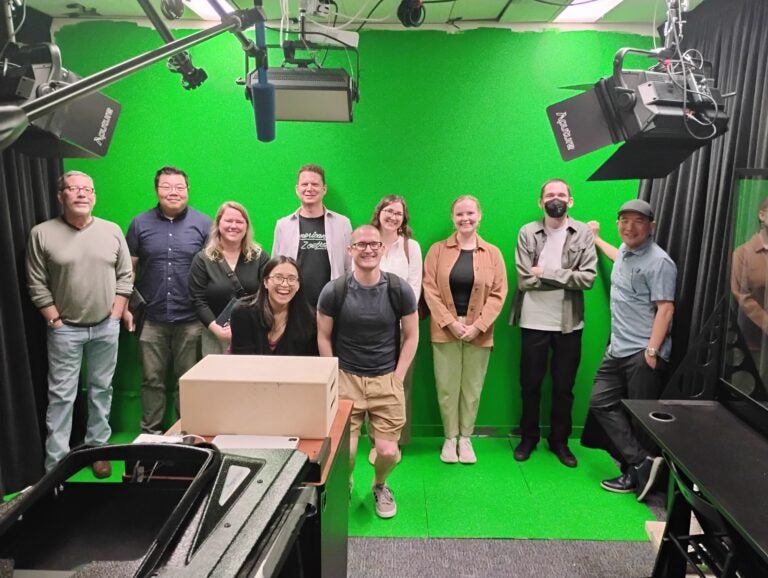 IDMP Staff on a green screen background