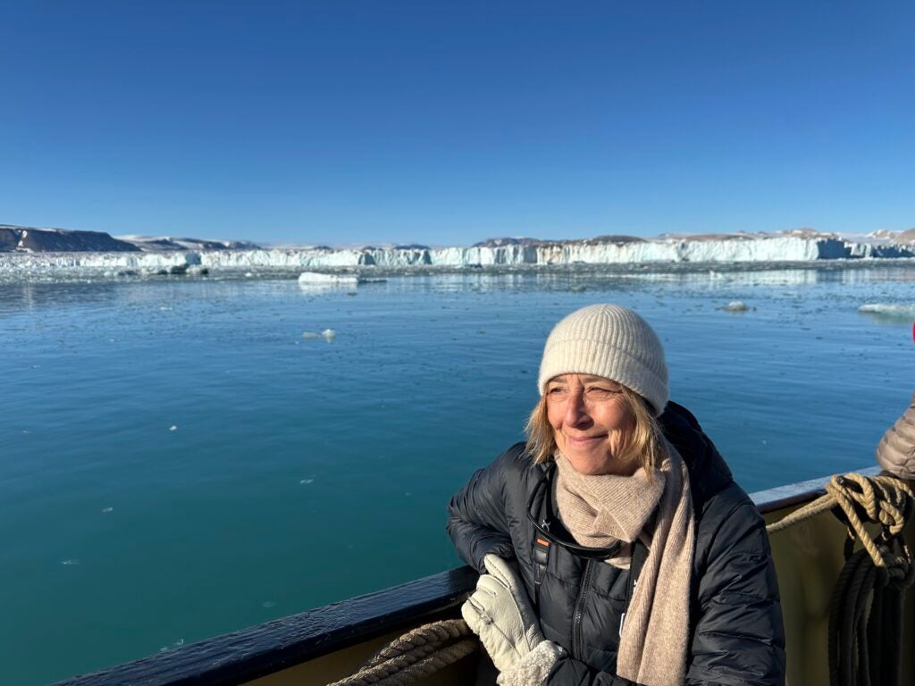 Rachel Kennison in a boat looking out at ice floes