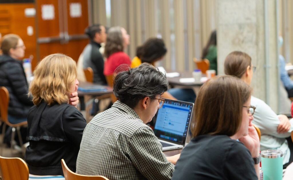 Photo of instructors on their computers