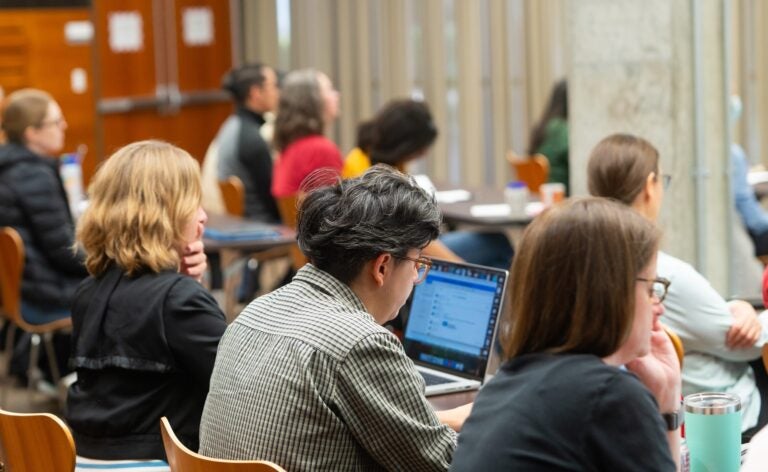 Photo of instructors on their computers