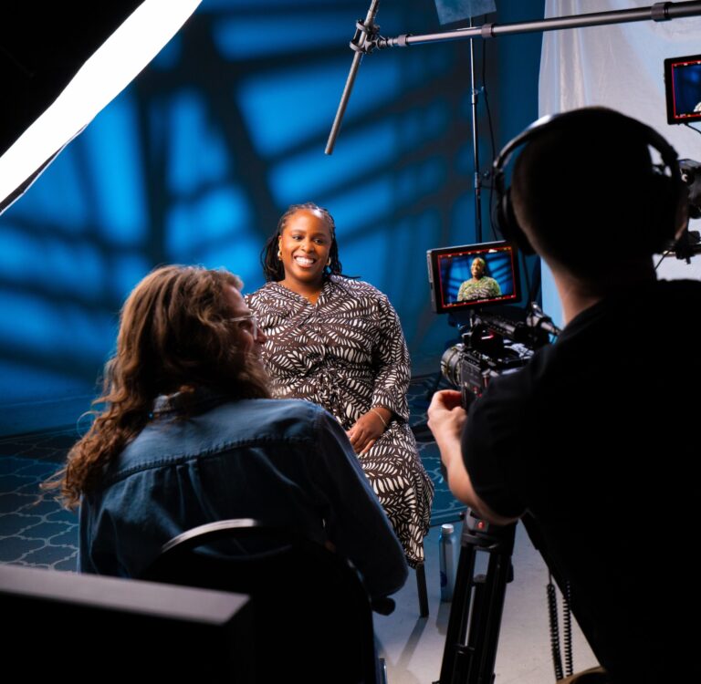 Photo of student being interviewed in front of a camera
