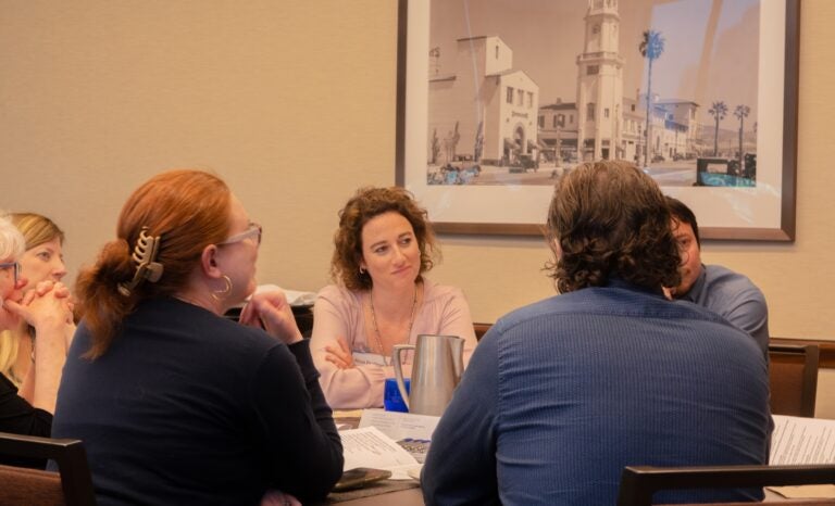 Photo of event attendees in discussion at a table