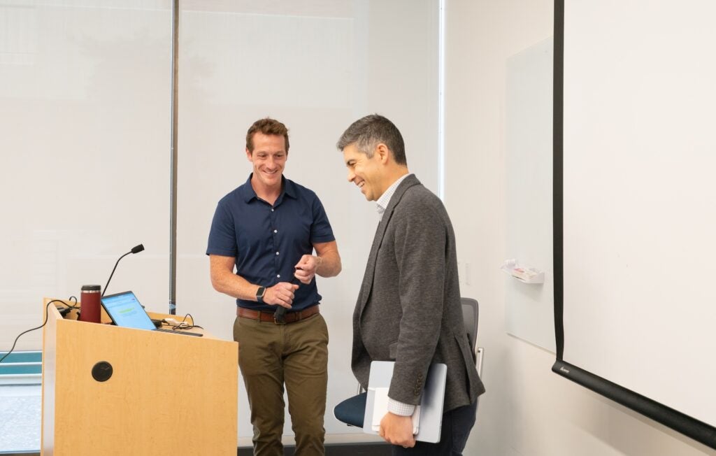 Photo of instructor and staff member talking