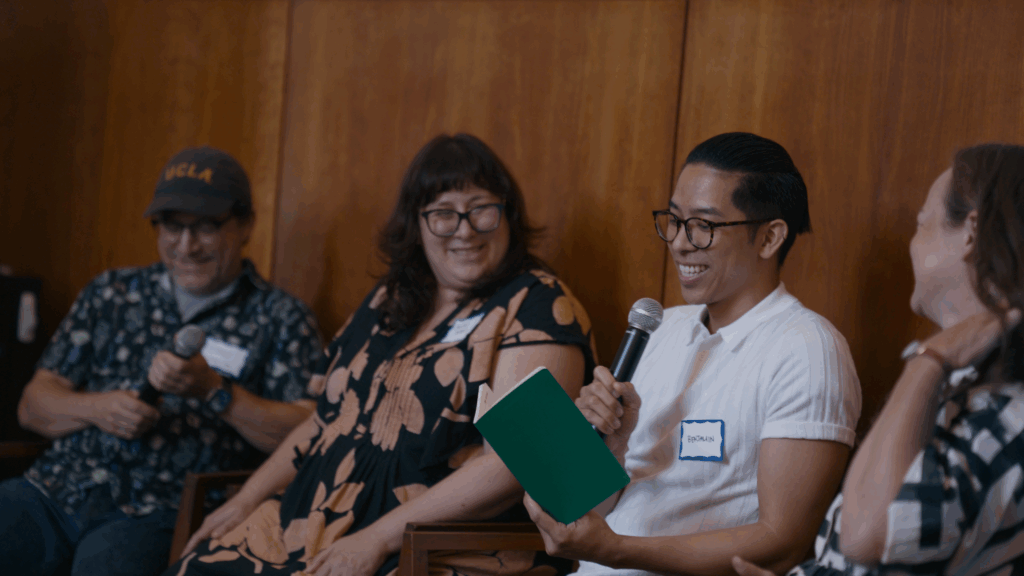 photo of conference participants with microphones