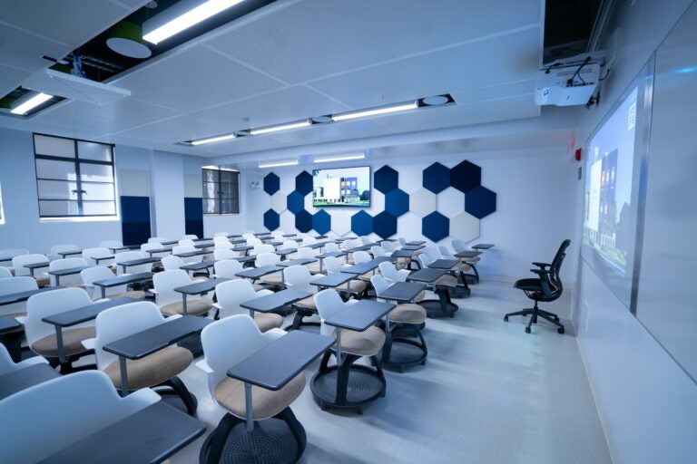Empty classroom with blue and white chairs and walls
