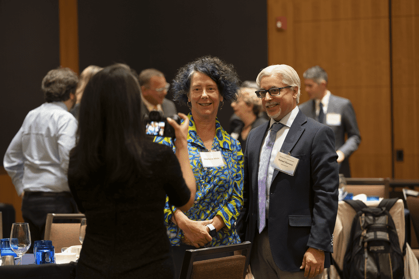 Photo of award recipient standing with a guest getting their photo taken.