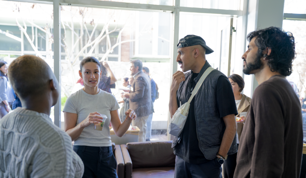 Students and staff in a circle conversing with each other about community-engaged learning opportunities