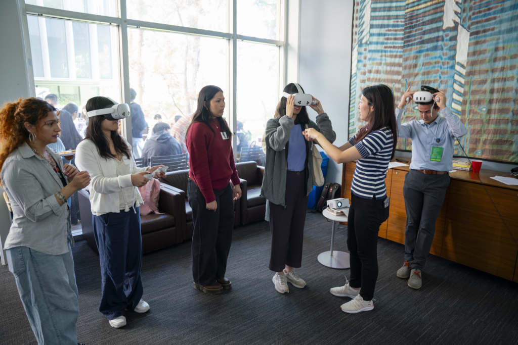 Students wearing VR headsets in a classroom with a staff member leading them