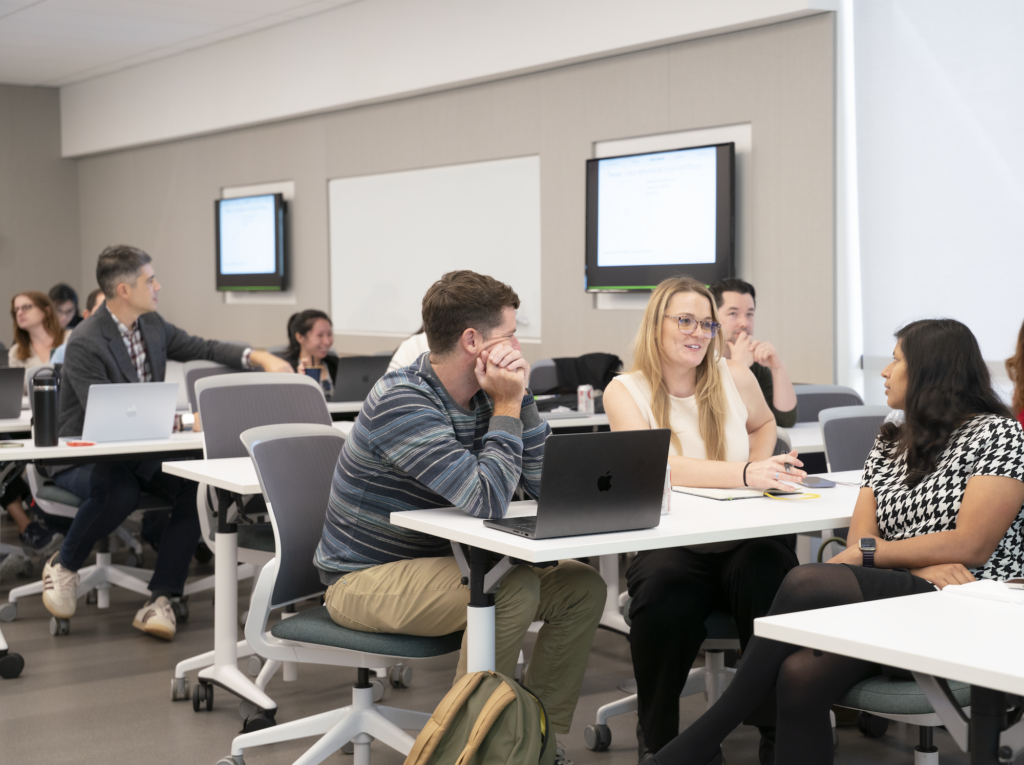 Teaching professors and staff in conversation at an event
