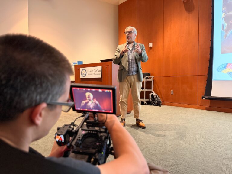 Media production staff member records an instructor's lecture.