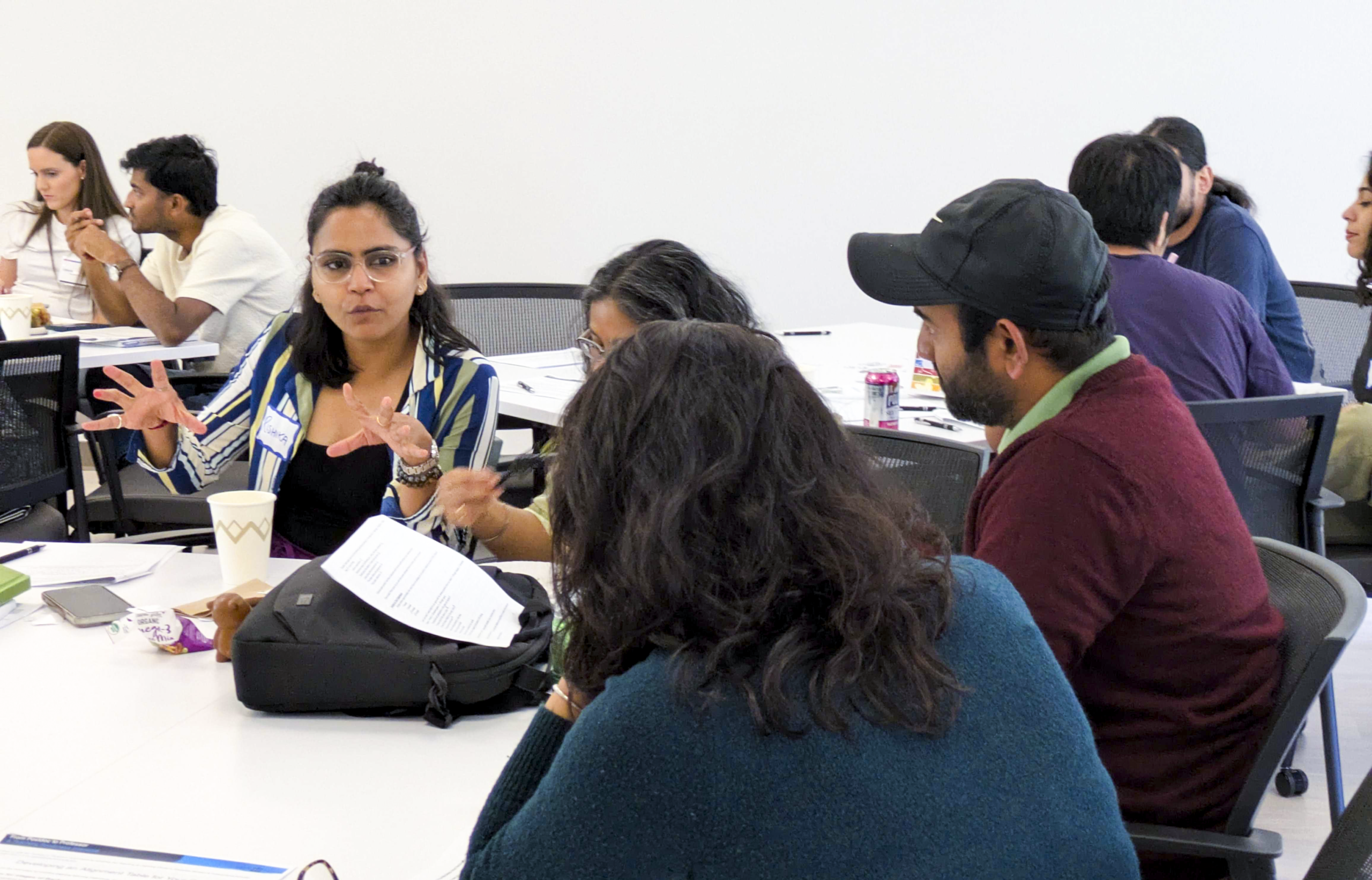 Postdoctoral scholars gathered at a table in conversation