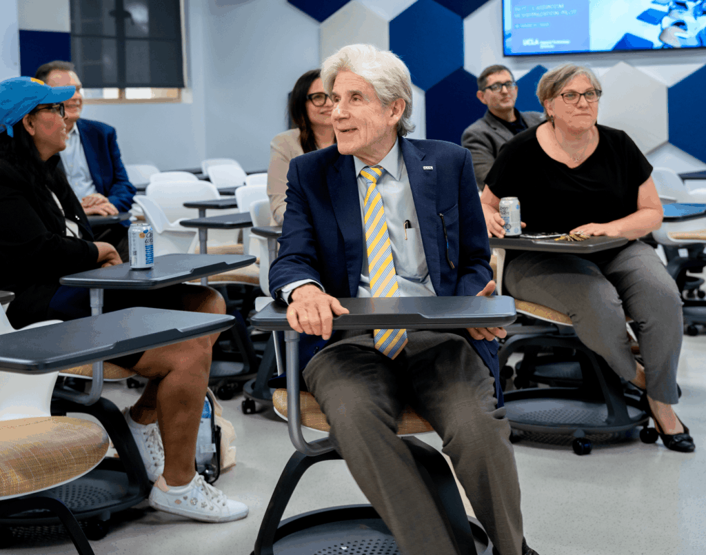UCLA Chancellor Julio Frenk seated in a modernized classroom smiling.
