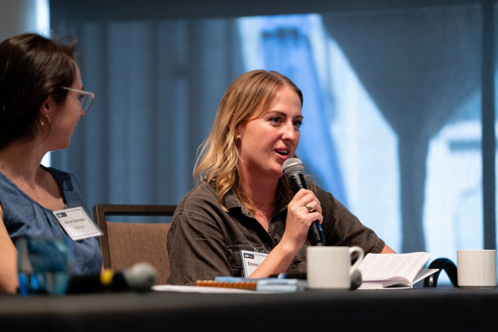 Ph.D student Emma Ridder speaks into a microphone at a desk.