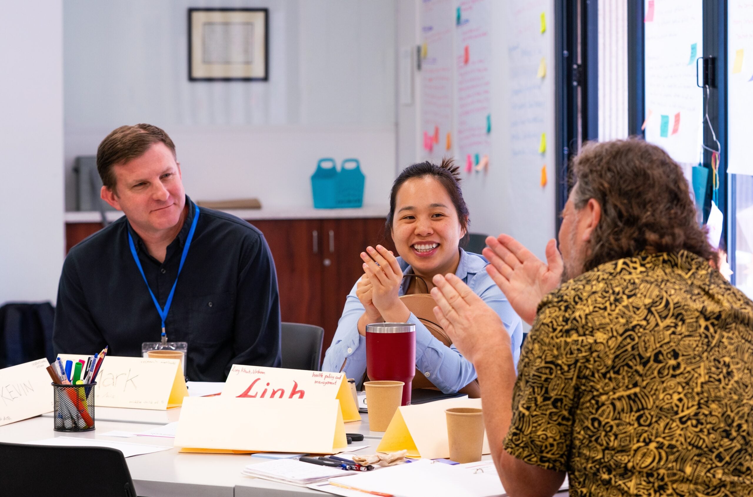 Summer Institute attendees in conversation at a table.