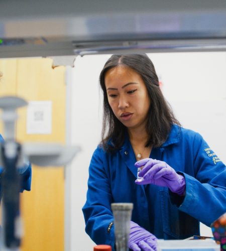 Teaching Assistant and student in a lab performing tests with equipment