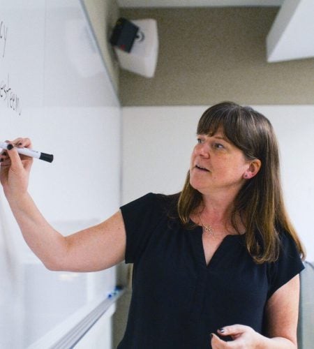 Instructor writing on a whiteboard