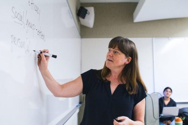Instructor writing on a whiteboard