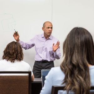 Photo of a professor on campus lecturing
