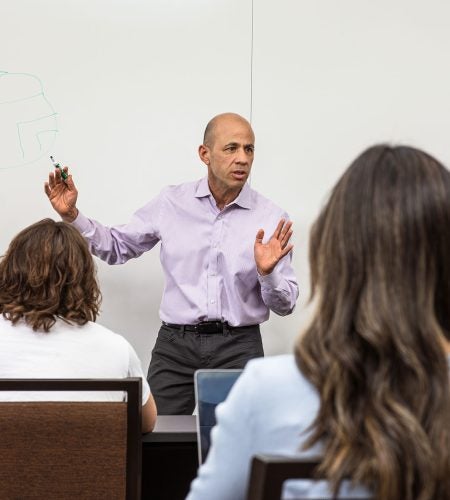 Photo of a professor on campus lecturing