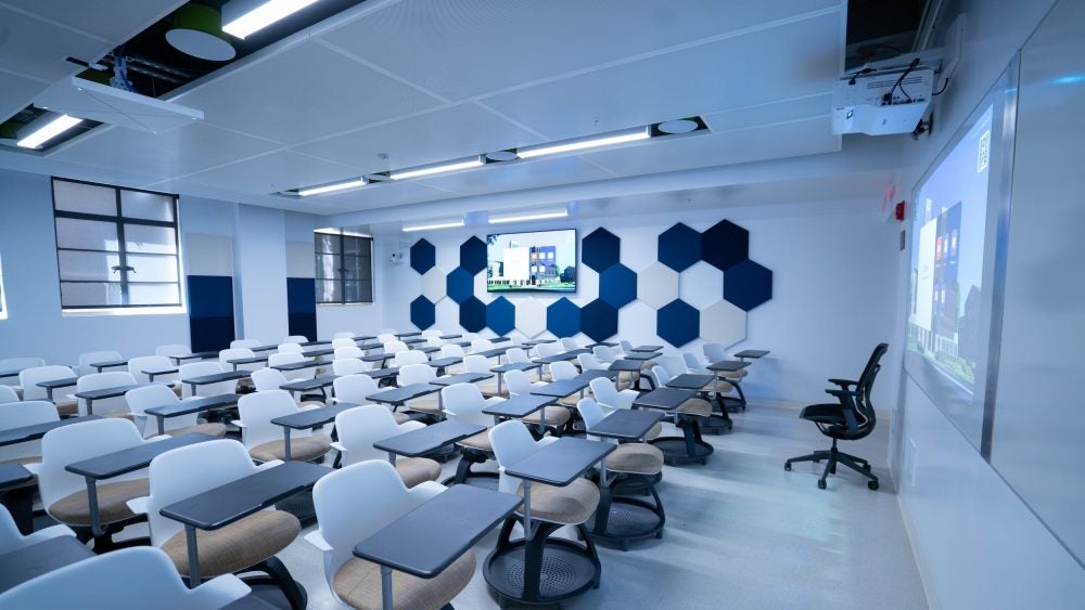 Empty classroom with blue and white chairs and walls