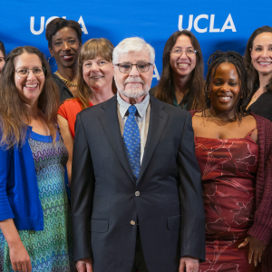 Collection of award winners and academic leadership against a blue UCLA background