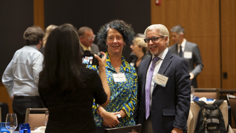 Photo of award recipient standing with a guest getting their photo taken.