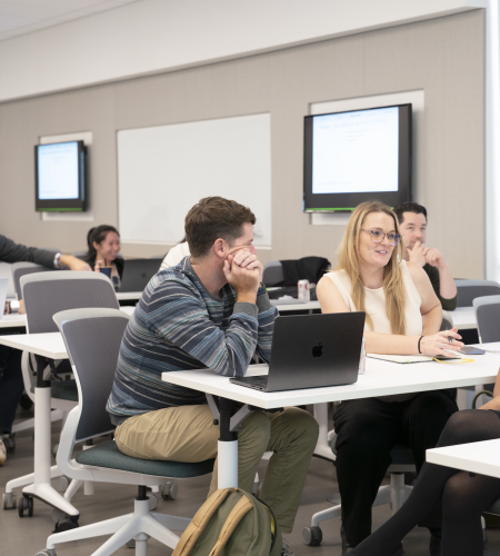 Teaching professors and staff in conversation at an event