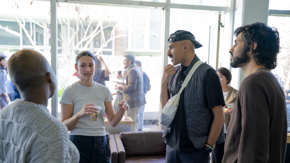 Students and staff in a circle conversing with each other about community-engaged learning opportunities