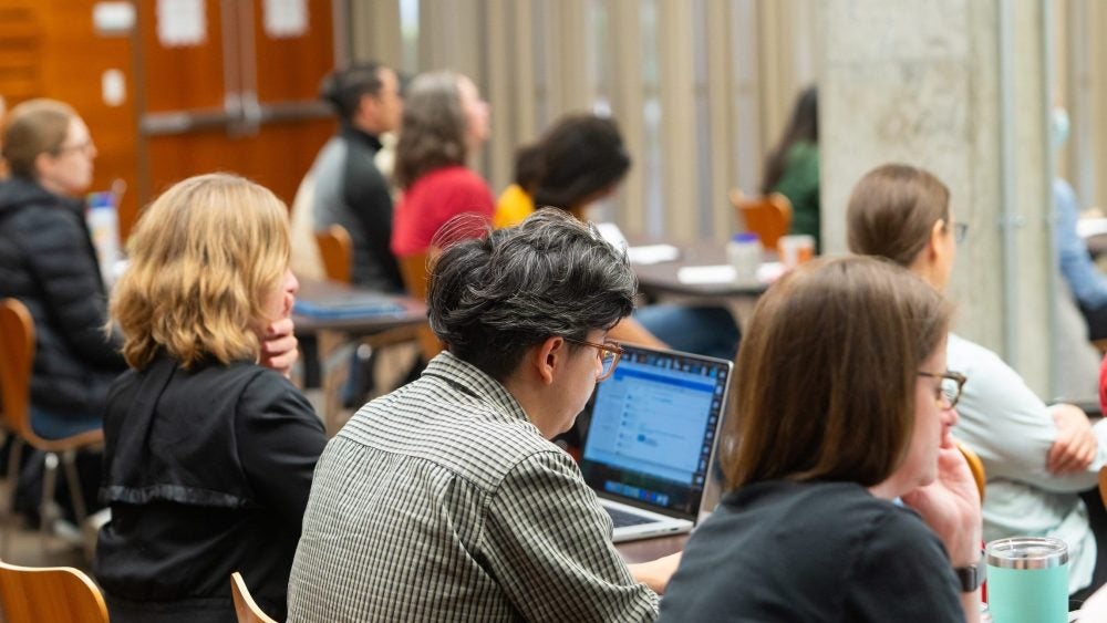Photo of instructors on their computers
