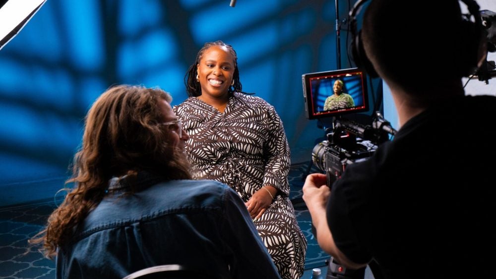 Photo of student being interviewed in front of a camera