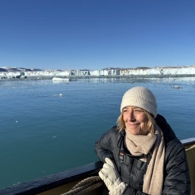 Rachel Kennison in a boat looking out at ice floes