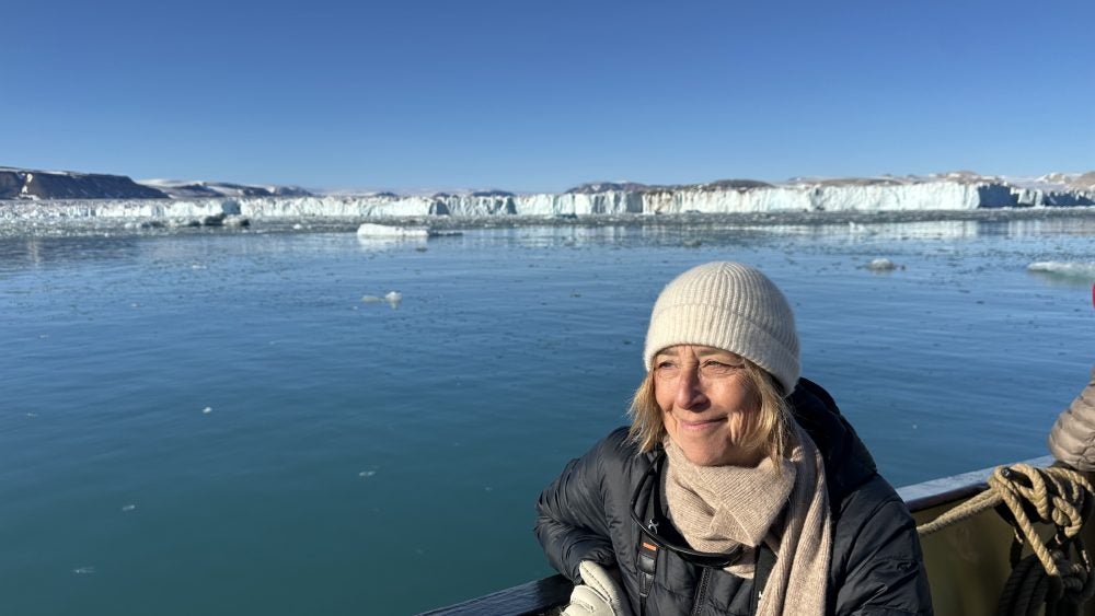 Rachel Kennison in a boat looking out at ice floes