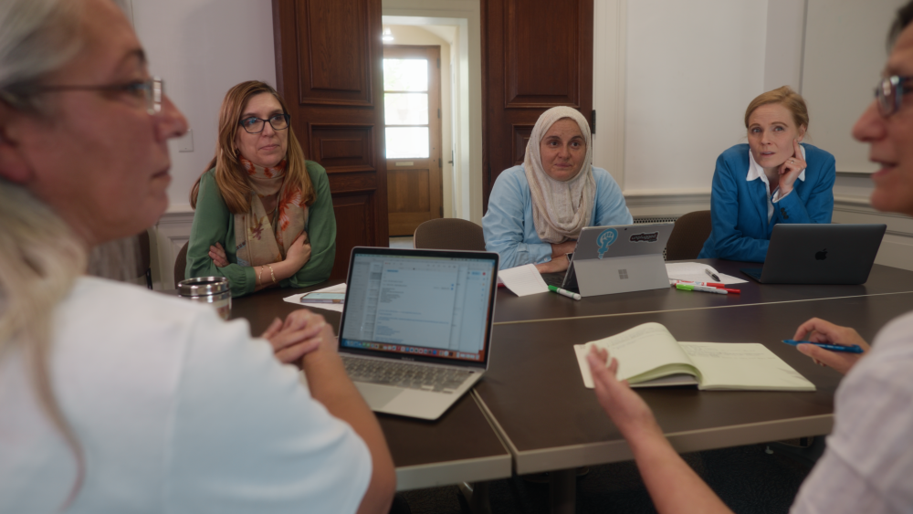 Holistic Evaluation of Teaching Participants working at a table