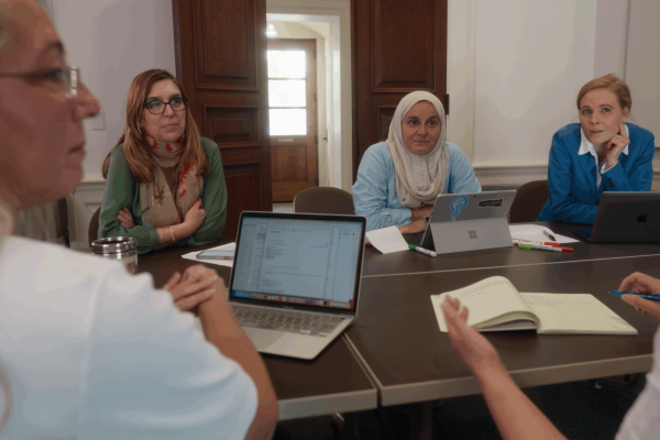 Holistic Evaluation of Teaching Participants working at a table