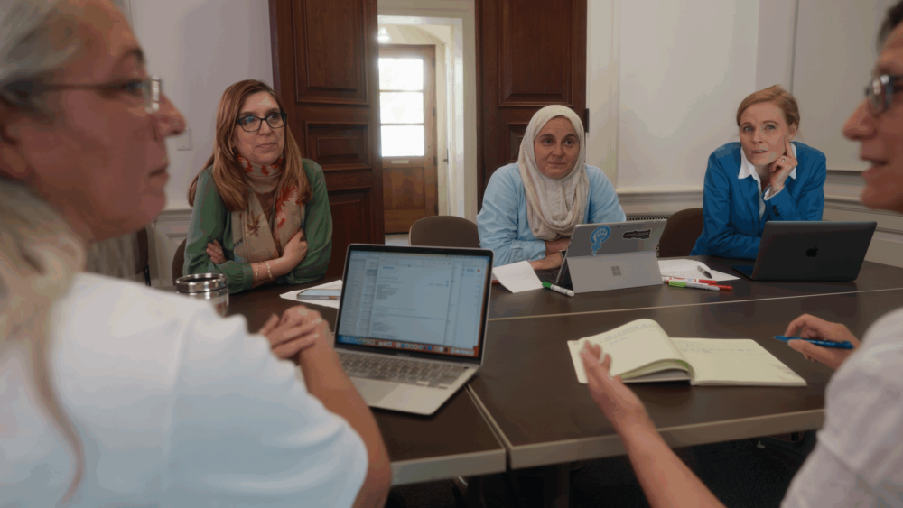 Holistic Evaluation of Teaching Participants working at a table