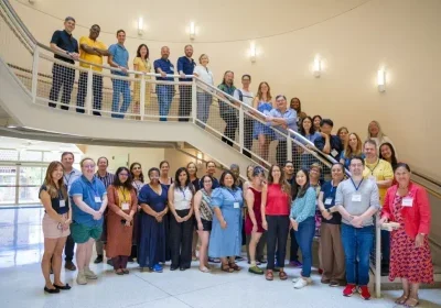 Participants and facilitators from the 2026 Summer Institute standing on a stairway.