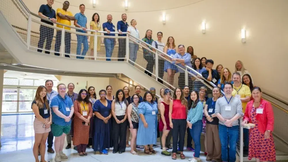Participants and facilitators from the 2026 Summer Institute standing on a stairway.