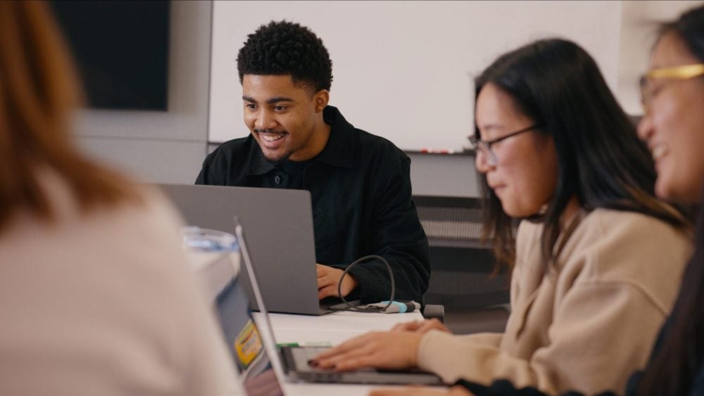 Individuals around a table at a TLC Event