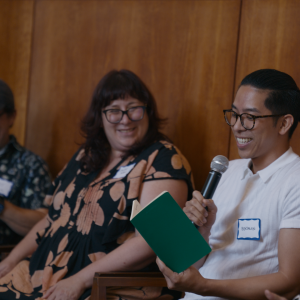 photo of conference participants with microphones