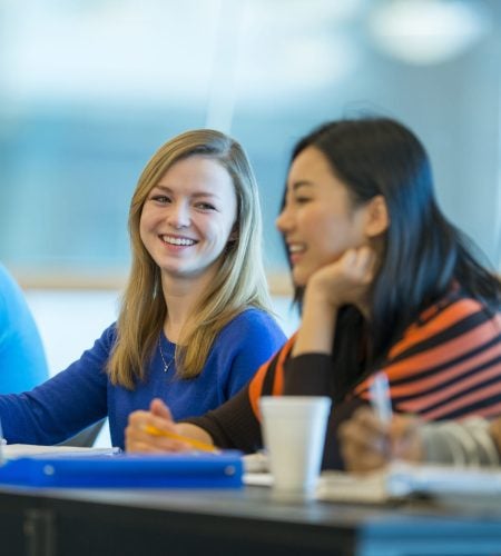 Diverse group of college students in class.