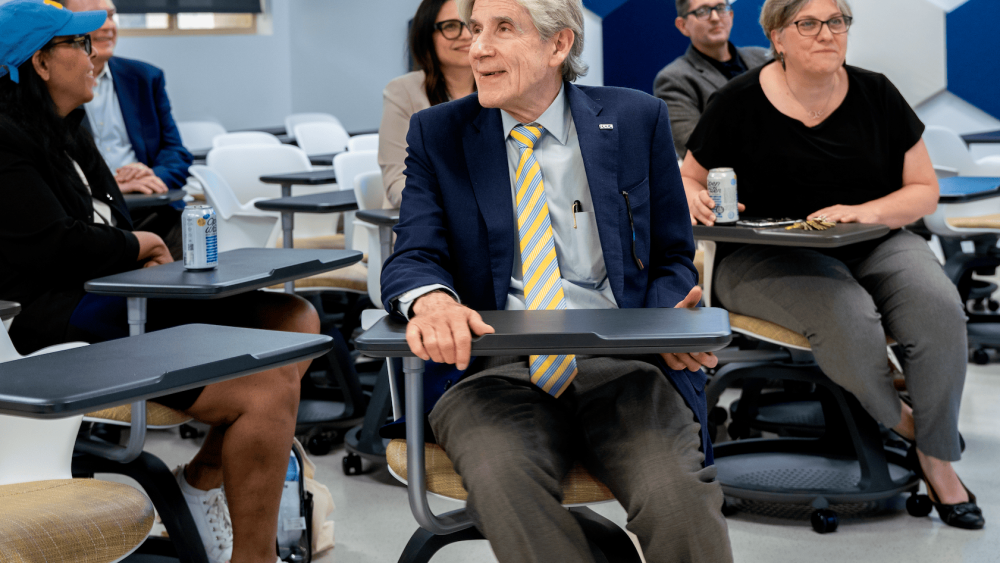 UCLA Chancellor Julio Frenk seated in a modernized classroom smiling.