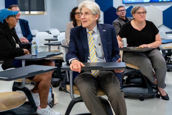 UCLA Chancellor Julio Frenk seated in a modernized classroom smiling.